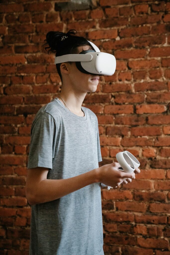 A young man enjoying virtual reality gaming indoors with a VR headset and controller.